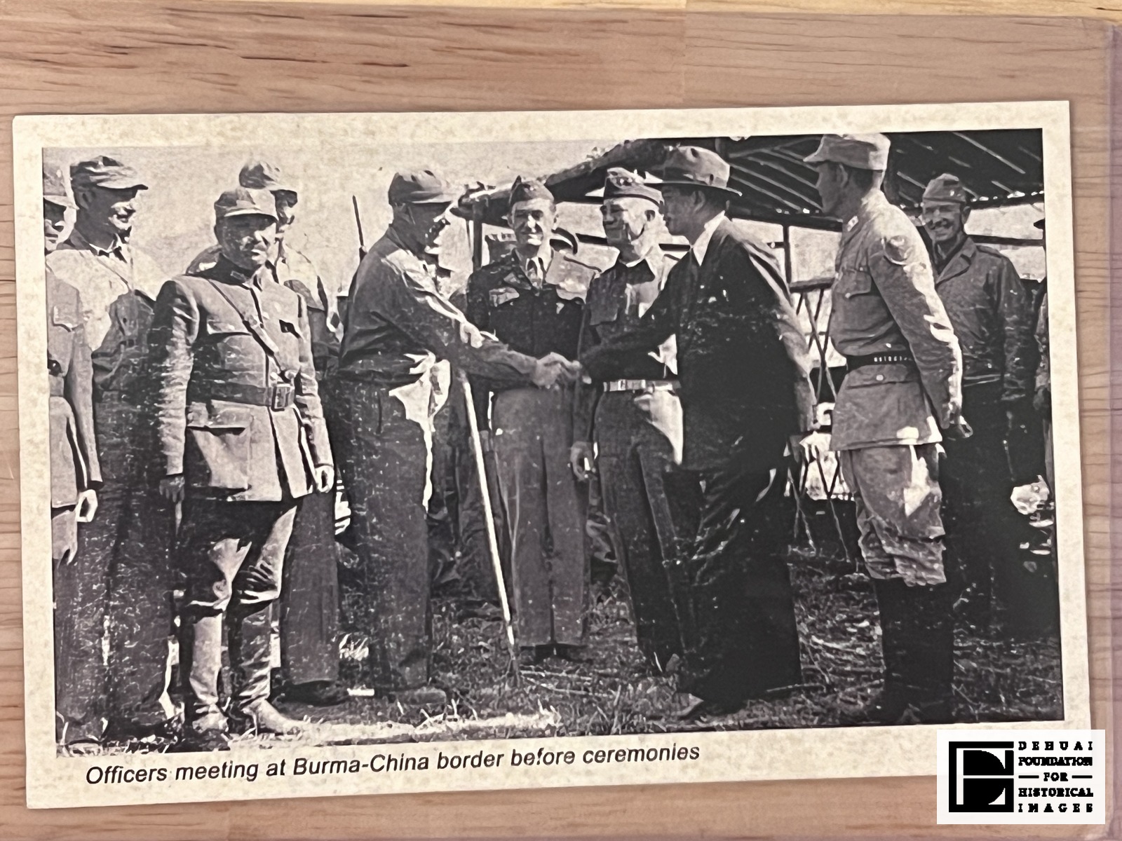 TFA-CA-130 — The face of the sheet, with the caption line 'Officers meeting at Burma-China border before ceremonies' set beneath the image.