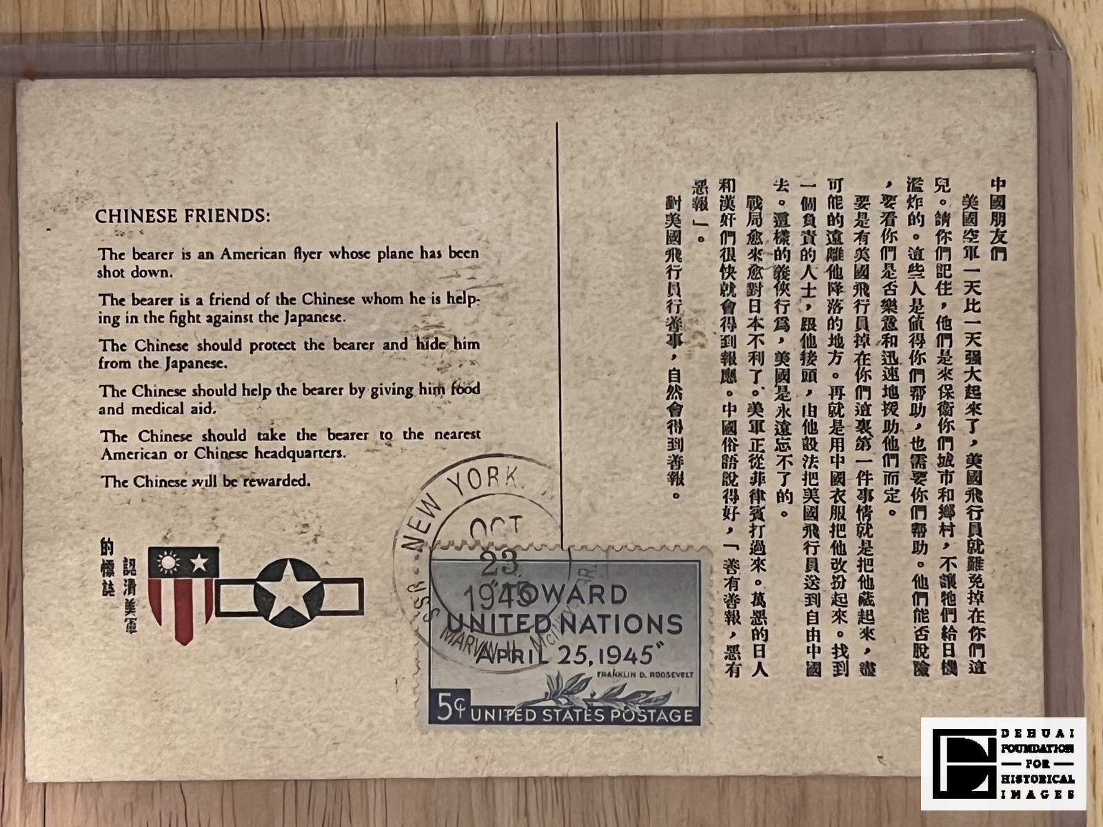 TFA-CA-136 — The printed face: the English bearer's notice at left with the Chinese-American shield and the United States star-and-bar aircraft insignia beneath it, the longer Chinese appeal at right, and the 5c "Toward United Nations" stamp tied by the U.S.S. Marvin H. McIntyre datestamp of 23 October 1945.